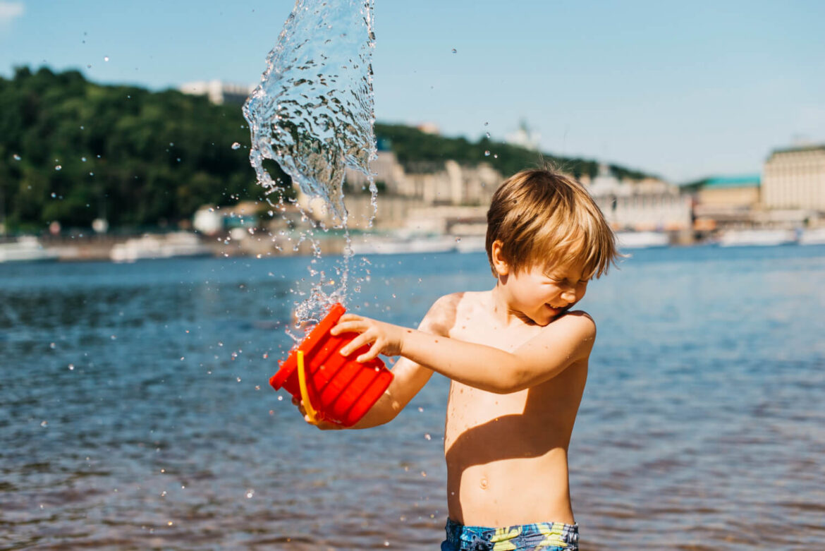 Junge spielt mit dem besten Strandspielzeug für Kinder im Wasser